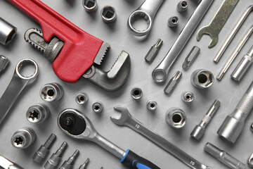 Poster - Different auto mechanic's tools on grey table, flat lay