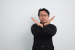© AnnaJannah - Asian Businessman with casual suit and shirt in studio showing cross hand as no or rejection, deny, prohibition with isolated white background