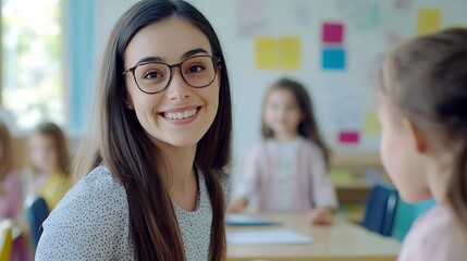 Aufkleber - Cheerful young female teacher working in elementary school happy teacher and girl smiling at camera in classroom interior : Generative AI