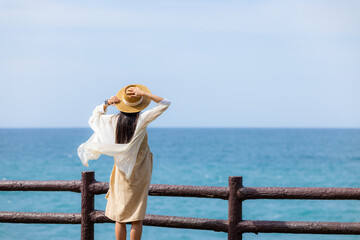 Wall Mural - Travel woman look at the blue sea