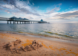 Wall Mural - Mettal boat ramp on empty sand beach. Amazing summer view of popular tourist attraction - Heringsdorf Pier with a lots of Shopping mail, Heringsdorf, Germany, Europe. Vacation concept background..