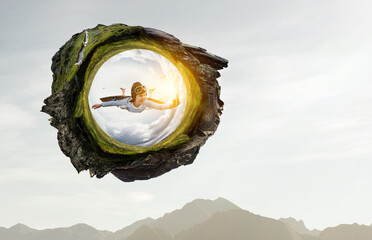 Happy little boy flying wearing helmet