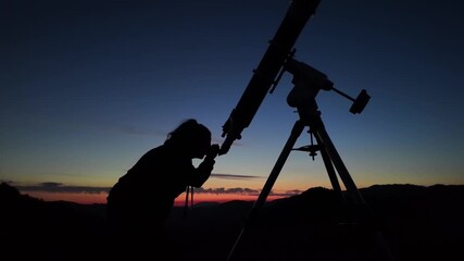 Wall Mural - amateur astronomer looking at the evening skies, observing planets, stars, moon and other celestial 