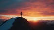 © SHI - A dramatic silhouette of a person standing on a mountain peak at sunset