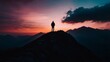 © SHI - A dramatic silhouette of a person standing on a mountain peak at sunset
