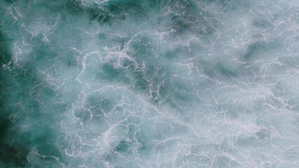 Wall Mural - Top down video of waves crashing in ocean near Uluwatu temple in Bali Indonesia