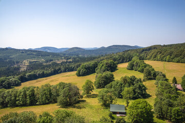 Wall Mural - Rolling hills and lush fields under blue sky