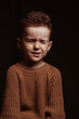 © alexkoral - Portrait of a frowning serious angry stylish white Caucasian child boy kid preschooler on a chair