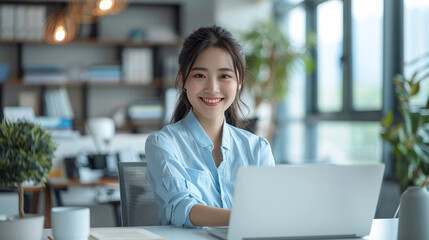 Aufkleber - A young Chinese woman was in the office, smiling broadly, dressed in light blue, sitting at a desk, working on a laptop. The background is white and clean. Generative AI.