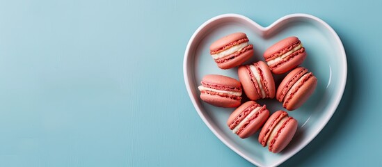 Aufkleber - Top view flat lay of a Valentine s Day greeting card with macaroons on a heart shaped plate against a blue background perfect for a copy space image