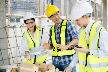 Wall Mural - Engineer teams meeting working together wear worker helmets hardhat on construction site