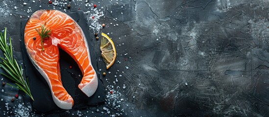 Poster - A fresh raw salmon steak displayed on a dark background ideal for cooking or grilling creating a striking image with available copy space