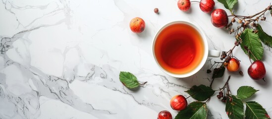 Sticker - Rose hip tea and fresh berries arranged on a white marble surface with ample copy space image