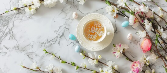 Aufkleber - Easter themed mock up featuring a teacup flowers and marble background with copy space image