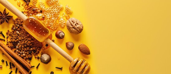 Poster - Top view of a honey dipper adorned with nuts and spices set against a yellow background providing a blank area for additional content like a copy space image