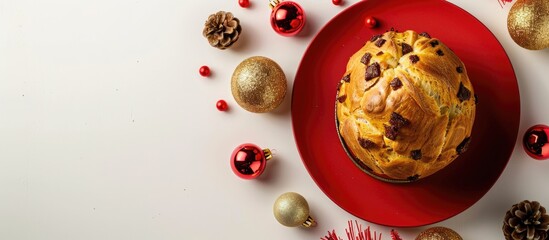 Poster - Mini Panettone a festive Italian sweet bread surrounded by Christmas decorations displayed on a red plate against a white backdrop with available space for text or images. Creative banner