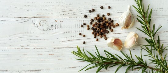 Poster - Garlic cloves black pepper and rosemary arranged on a white wooden table with copy space image