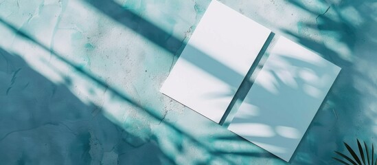 Poster - Two blank A4 poster and business card mockups placed diagonally on a stylish mint blue concrete backdrop with rainbow light refractions and a shadow for a modern look. Creative banner. Copyspace image