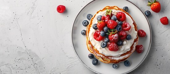 Aufkleber - Pancakes topped with berries and cream on a plate with copy space image