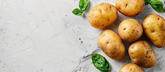 Poster - Top view of fresh organic potatoes on a white backdrop with copy space image