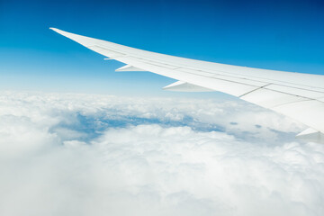 Wall Mural - view from an airplane on a blue sky and white clouds