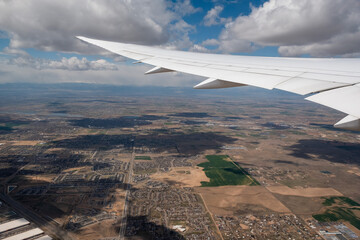 Wall Mural - view from an airplane on a blue sky and white clouds