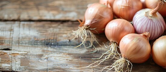 Poster - On a wooden surface fresh onion bulbs are displayed with copy space image