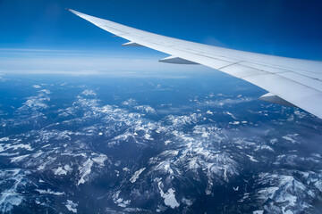 Wall Mural - view from an airplane on a blue sky and white clouds