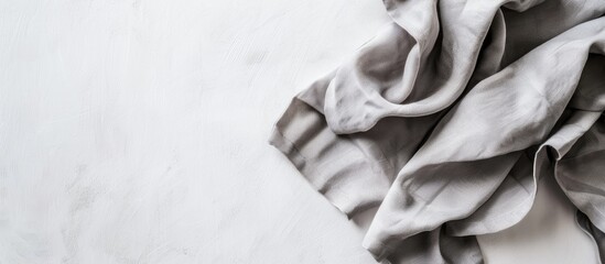Poster - View from above of a gray kitchen napkin placed on a table background perfectly folded with an area for text or design in a minimalistic flat lay style. Creative banner. Copyspace image