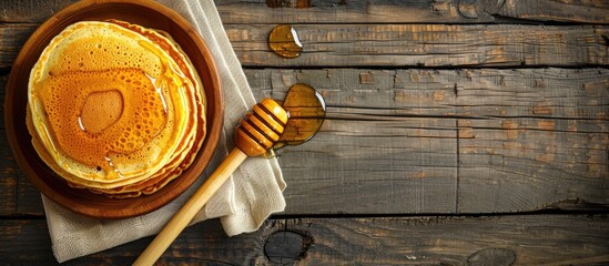 Poster - Wooden table with pancakes drizzled in honey featuring ample copy space image
