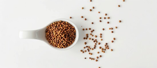 Poster - A top view studio shot of Brassica hirta mustard seeds in a white spoon on a white background with soft light providing copy space for an image