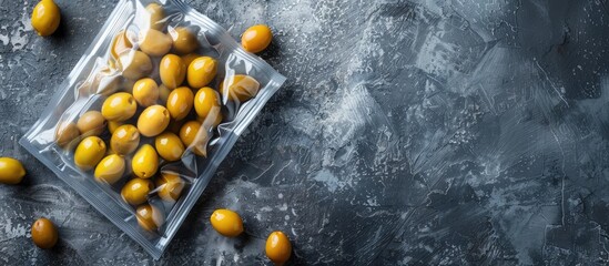 Poster - Top view of olives in an unlabeled vacuum pack on a gray stone table with space for text in the image. Creative banner. Copyspace image
