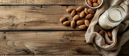 Sticker - Rustic wooden table with almonds almond milk bottle and copy space image