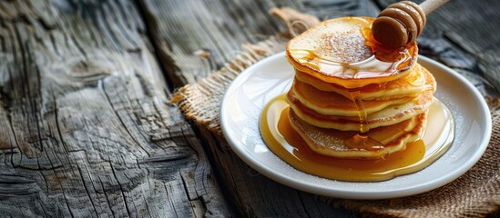 Poster - Traditional Russian Ukrainian dessert Syrniki on a white plate with honey set against a wooden background offering space for additional images