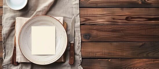Poster - Wooden table with dishes set beside empty note paper allowing for copy space image