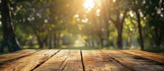 Poster - Product displayed on a wooden table with a blurred background of trees with bokeh effect providing ample copy space image