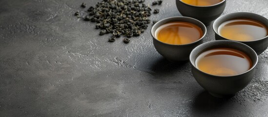 Poster - Grey table with a serving of brewed Tie Guan Yin Oolong tea perfect for adding text in the copy space image