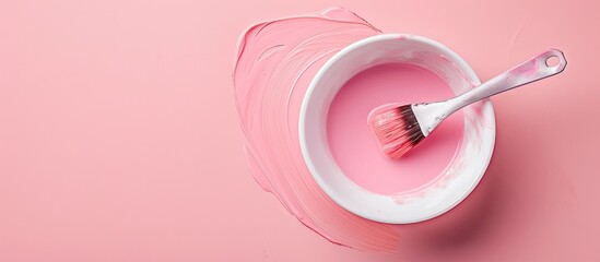 Poster - Mixing bowl with brush containing hair dye on a pink backdrop providing copy space image