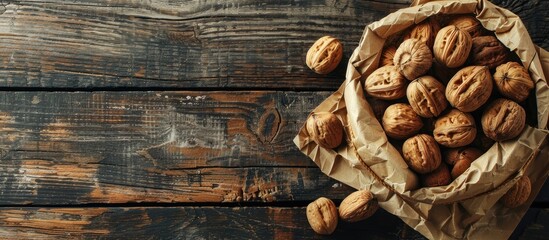 Aufkleber - Walnuts in a paper bag on an old rustic table viewed from the top with copy space image available