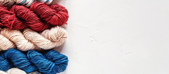 Poster - Horizontal photo of red white and blue wool yarn on a white backdrop with space on the left for text or other elements. Creative banner. Copyspace image