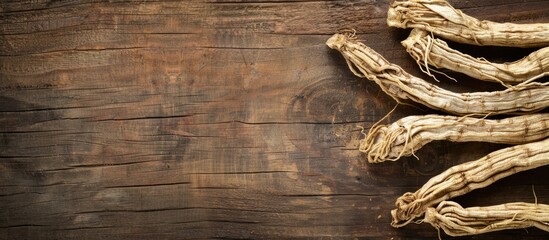 Poster - Wood background with copy space image featuring dried Korean ginseng