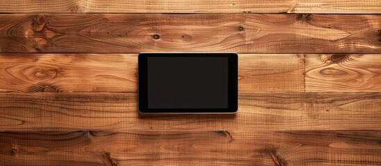 Poster - Wooden desk with a modern tablet on it from a top view ideal for incorporating your copy space image