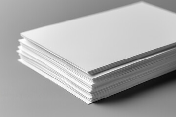 Top view of two white open paper cards on a gray background with soft shadows and space for text