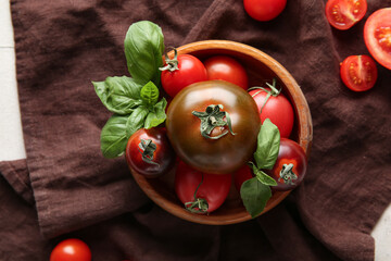 Wall Mural - Tomatoes in bowl on cloth on white tile background. Closeup