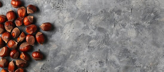Leinwandbilder - Flat lay of scrumptious roasted chestnuts on a grey tabletop with copy space image available