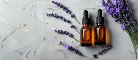 Poster - Top down view showcasing two unbranded cosmetic serum bottles alongside a fresh lavender bunch on a grey backdrop featuring ample space for additional imagery
