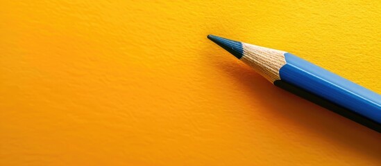 Aufkleber - Yellow background with a blue pencil leaving a blank copy space image