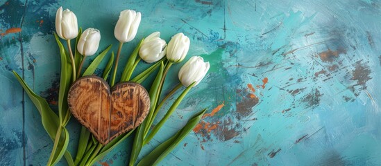 Sticker - A serene lifestyle composition for a holiday featuring white and green tulips arranged next to a wooden heart on a rustic turquoise concrete backdrop with copy space image