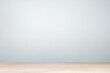 © ItziesDesign - A minimalistic background featuring a smooth, light gray wall and a wooden floor, perfect for presentations or product showcases.