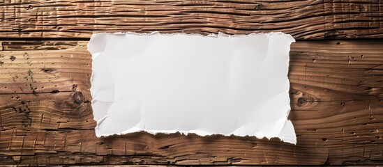 Wooden surface with a white paper suitable for use as a copy space image